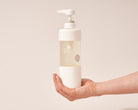Dirt wool and delicate wash bottle being held in hand