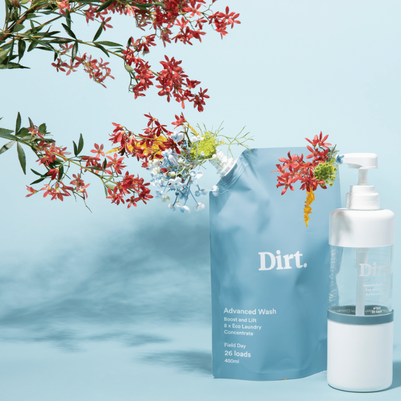 Dirt advanced wash refill and bottle on blue background with flowers